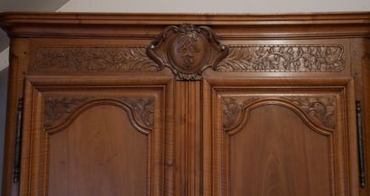 null A large natural wood wedding cabinet with two three-panel doors, the pediment...