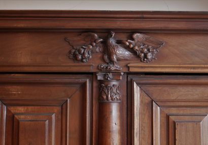 null Walnut and stained walnut sideboard with half-columns opening to four panels...