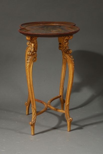 null A pedestal table with a wooden top painted with children playing, with a four-legged...