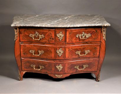 null A Louis XV style veneered chest of drawers with four drawers on three rows and...