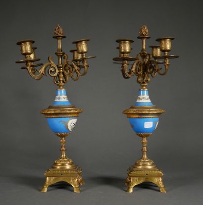 null A pair of bronze and porcelain candelabras decorated with flowers in medallions...