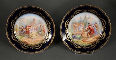 null Pair of plates in polychrome porcelain with galant scenes on a blue and gold...