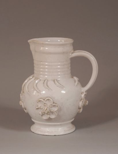 null Earthenware pitcher with cream engobe and flowers in relief

H : 30 cm. (ch...