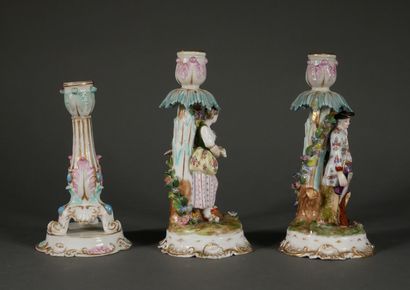 null Lot :

- Pair of polychrome porcelain candlesticks decorated with a couple of...