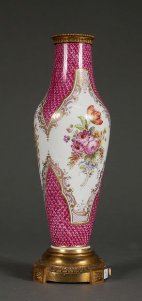 null A polychrome porcelain baluster lamp base with flowers in medallions on a pink...