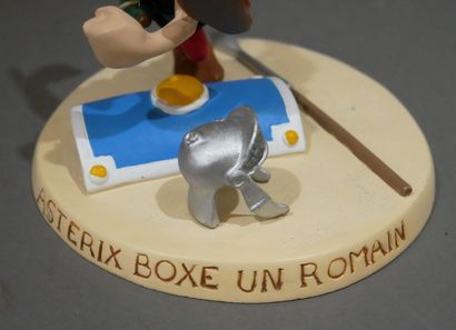 null UDERZO - GOSCINNY

Scene of two collectible figurines: Asterix boxes a Roman...