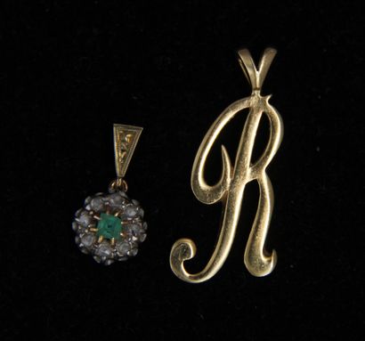 null *Lot of two 18k gold pendants:

- one in the shape of an R, wt: 3.3 g.

- one...