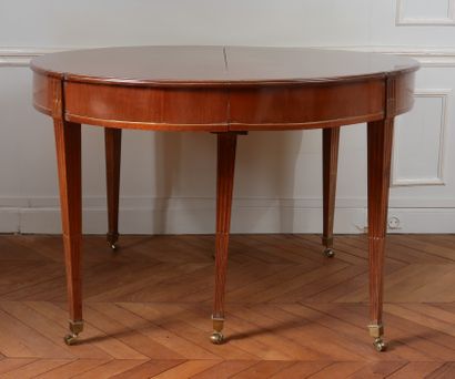 null Mahogany veneered oval dining room table resting on six fluted legs.

	19th...