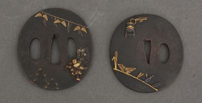 null Two tsuba maru-gata, one decorated in takazogan and gold highlights, with two...
