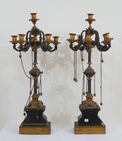 null Pair of candelabras in patinated bronze, gilded on a black marble base

H :...
