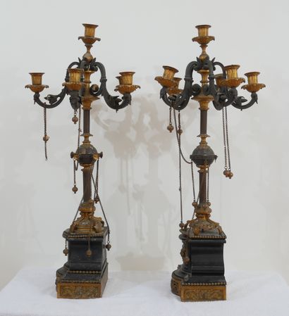 null Pair of candelabras in patinated bronze, gilded on a black marble base

H :...