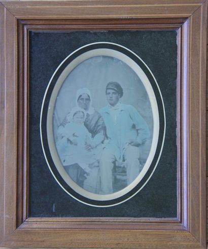 Oval photograph of a couple with their child
15...