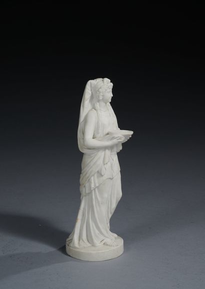 null Bisque porcelain statuette representing a vestal, draped, and holding a cup...