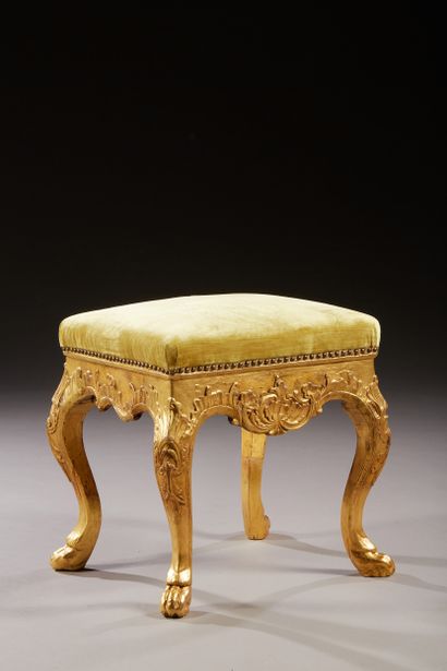 null Rectangular stool in carved and gilded wood, decorated with rocaille cartouches...