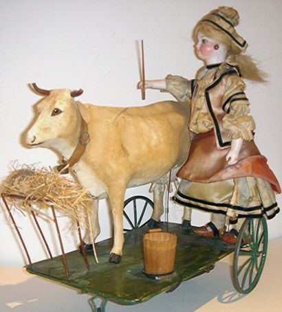 null Jouet mécanique G. VICHY représentant une fermière avec sa vache à l'étable,...