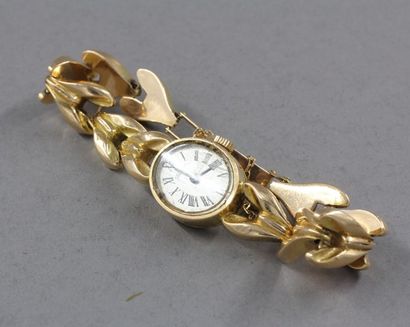 null *Bracelet-montre de dame en or jaune 18k, pds brut : 19,6 g.