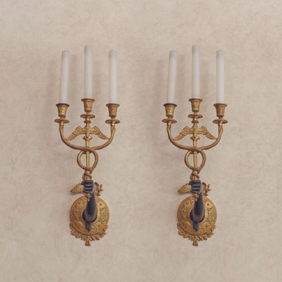 null 
A pair of sconces in green patina bronze and gilt bronze, with three branches...