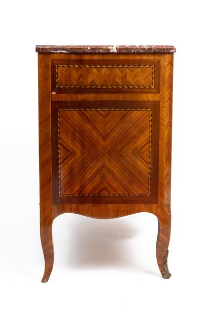 null Chest of drawers with a slight central projection in rosewood marquetry in frames...