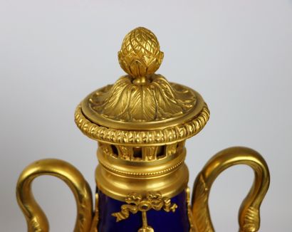 null A pair of deep blue enamelled porcelain and gilt bronze covered vases with swan...