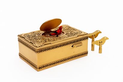 null Rectangular music box in gilded brass, richly chased and embossed with filigree...