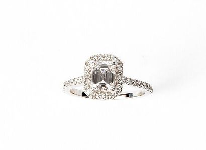 null White gold ring set with a central emerald cut diamond weighing 0.70 carat....