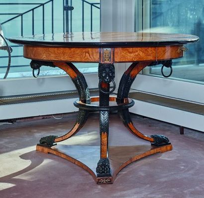 null 
A large mahogany veneered and carved wood pedestal table with a black patina...