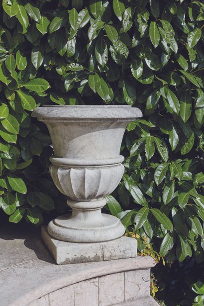 null 
A pair of garden vases in white veined marble, the body carved with repeated...