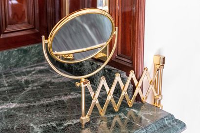 null Gilded brass magnifying mirror with a deployant bracket.

H_37 cm