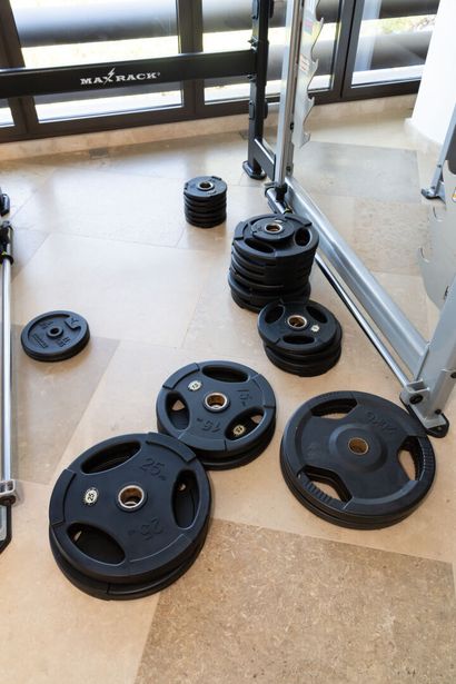 null Set of dumbbells on a stand and a set of kettle bells.