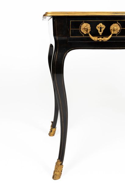 null Small flat desk in blackened wood and ornamentation of gilded bronzes and nets...