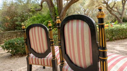 null Pair of small blackened and gilded wood armchairs, the backs supported by fluted...