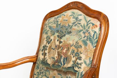 null Pair of flat-backed armchairs in molded and carved wood, the belt decorated...