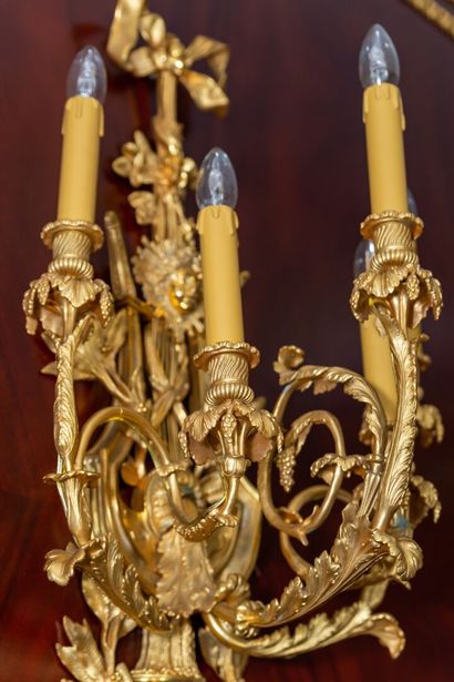 null Pair of important ormolu five-light sconces decorated with radiating female...