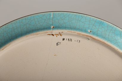 null LONGWY.

Earthenware cake dish with polychrome enamels in relief decorated with...