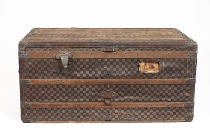 null MOYNAT, Paris.
Large mail trunk in coated canvas with checkerboard decoration,...