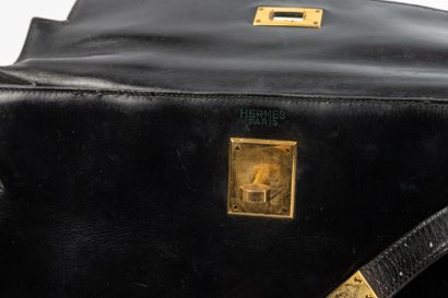 null HERMES, Paris. 
Kelly" bag 32 cm in black box calf, gold-plated metal trim....