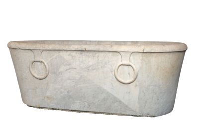 null Oval bathtub in carved white marble, decorated in relief with two rings on one...