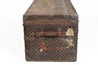 null MOYNAT, Paris.
Large mail trunk in coated canvas with checkerboard decoration,...