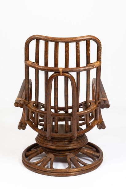 null AUDOUX-MINET, in the taste of. 
Important swivel armchair in dark rattan and...