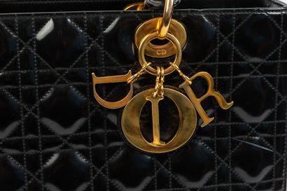 null DIOR.
Lady Dior" bag in black patent leather, gold metal jewelry. 
Inside red...