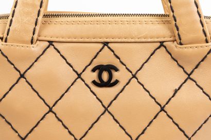 null CHANEL, Paris.
Handbag with double handle in beige lambskin, black stitching....