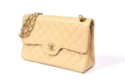 null CHANEL, Paris.
Timeless" bag in quilted beige lambskin leather, gold-tone metal...