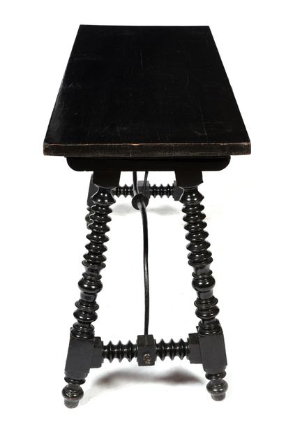 null Richly turned, stained and reblackened wood table with rectangular top.
Ringed...