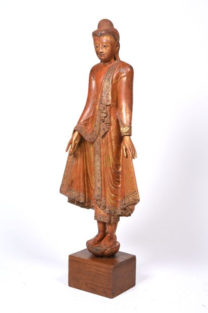 null SIAM 18th-19th century. 
Standing Buddha in gilded wood with rust-colored lacquer...