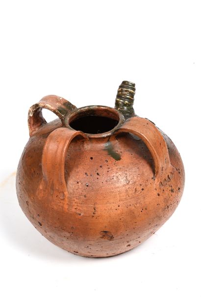 null Terracotta oil jug with brown-green glaze on part of the body.
The body is ribbed...