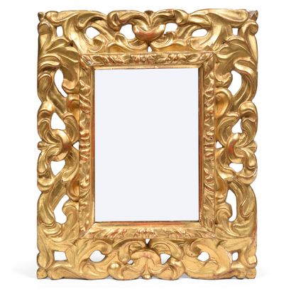null Rectangular gilded wood mirror decorated with large openwork foliage. 
Italy,...