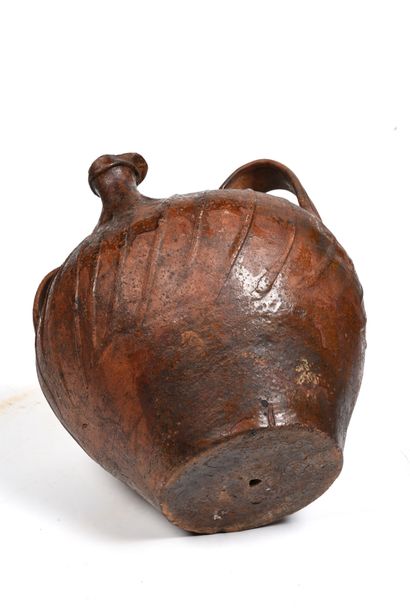 null Terracotta oil jug with brown glaze.
The body has sloping ribs.
Three handles...