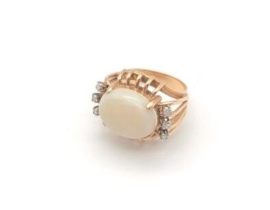 null Ring in 585 yellow gold, with a cabochon opal and three diamonds on each side,...