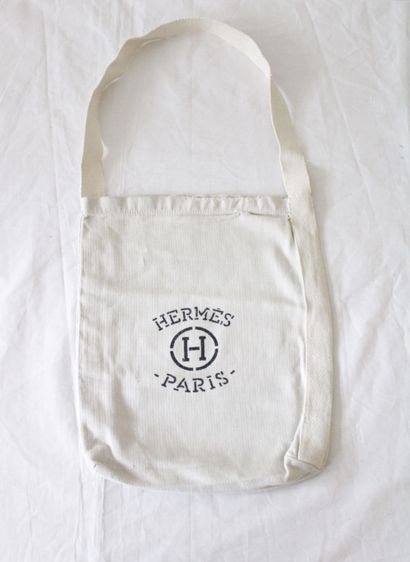 null HERMES, Set of two ecru fabric dressing bags/totebags with the brand's logo,...