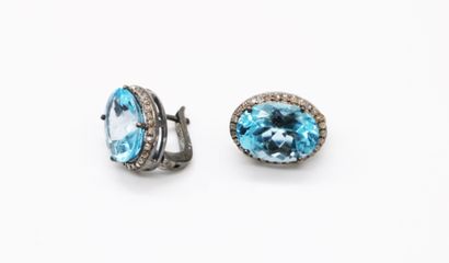 null *Pair of 925 blackened silver sleepers set with oval-cut blue topazes in a diamond...